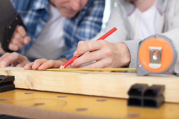 carpenter with pencil and folding rule