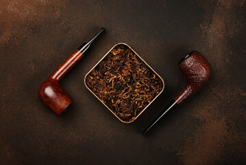 Wall Mural - Tin of coarse cut tobacco and pipes over brown