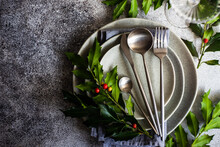 Festive Place Setting With Holly Decorations For Christmas