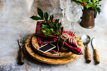 Festive Place Setting With Holly Decorations For Christmas