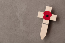 A Red Remembrance Poppy On A Wooden Cross. Military Remembrance Day Concept