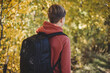 © Lyubov - Teenager boy with backpack walking on path in autumn park. Active lifestyle, Back to school. Student boy in fall forest. People from behind