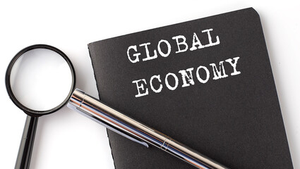 Poster - GLOBAL ECONOMY - business concept, magnifier with white text message on black notebook