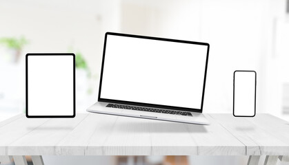 Wall Mural - Laptop, tablet and phone with isolated display for mockup, levitating above the desk. Creative responsive design promotion concept