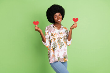 Sticker - Photo of young afro girl happy positive smile hold little paper heart feelings date romantic isolated over green color background