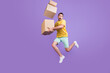 Full body profile side photo of young guy jump hold boxes air postal service isolated over purple color background