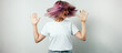 Pretty plus size model with white blank t-shirt and pink hear, empty grunge wall background, joyfully shaking hear