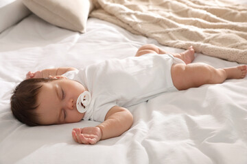 Sticker - Cute little baby with pacifier sleeping on bed