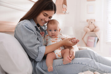 Wall Mural - Mother with her cute baby on bed at home