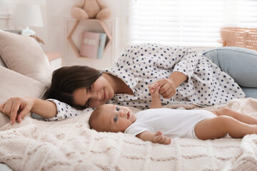 Poster - Mother with her cute baby on bed at home