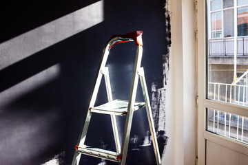 Home renovation concept - Ladder for home renovation works and painted wall