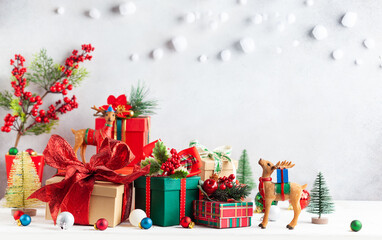 Poster - Christmas or New Year gift boxes and Christmas ornaments on wooden table. Festive decorations and presents for winter holidays.