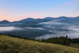 Fototapeta Niebo - Amazing view of beautiful mountain landscape covered with fog