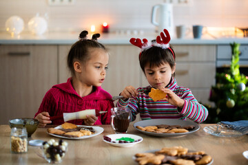 Wall Mural - Little children decorating Christmas cookies for celebration at home 