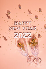 Wall Mural - Festive new year flat lay with numbers 2022 and hard shadows with glasses and shiny decor