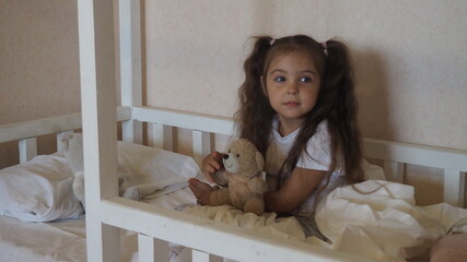 little cute girl is going to go to bed. indulges in, does not want to sleep. naughty. cute little gi