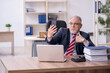 © Elnur - Old male employee working in the office