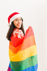 Wall Mural - christmas lgbtq rainbow flag. happy lesbian latin young woman celebration