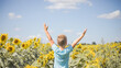 © Maria - Happy child field Freedom and happiness concept on sunflower outdoor. Kid having fun in green spring field against blue sky background. Healthy and active lifestyle concept
