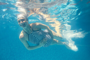 Wall Mural - Pregnant woman in the pool.