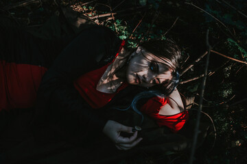 Wall Mural - girl in a historical dress in a coniferous forest