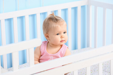 Sticker - Cute baby girl in cot at home