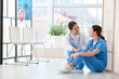 © Pixel-Shot - Female Asian doctor calming her colleague in clinic