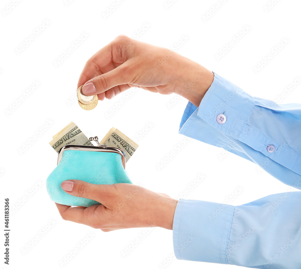 Woman putting coins into wallet on white background