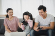 © chokniti - daughter children with mother and father are happy at home family together, lifestyle of Asian young girl with smile face are fun in a house with mom and dad