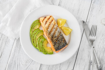 Wall Mural - Fried salmon with avocado slices