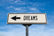 Dreams road sign, arrow on blue sky background. One way blank road sign with copy space. Arrow on a pole pointing in one direction.