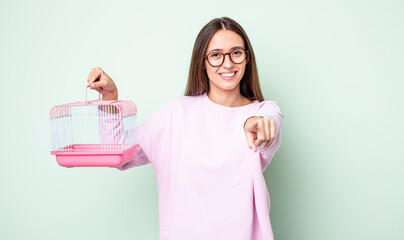 Poster - young pretty woman pointing at camera choosing you. pet cage concept