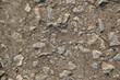 The surface of gray stones lay on the floor, mud and pebbles. It was crushed and cracked. Use for website background or banner and template.