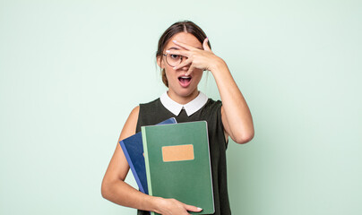 Poster - young pretty woman looking shocked, scared or terrified, covering face with hand. universitary concept