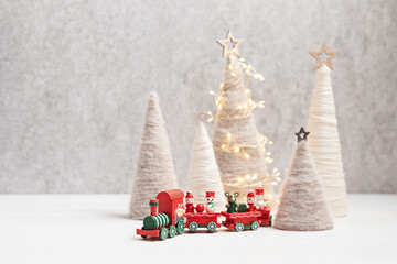 Christmas craft background with handmade yarn cone xmas trees in natural colors.  DIY organic sustainable christmas decoration