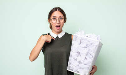 Poster - young pretty woman feeling happy and pointing to self with an excited. paper balls trash concept