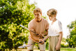 © Drobot Dean - Ginger man teaching his son how to play badminton in park