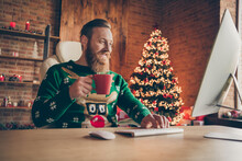 Photo Of Cheerful Relaxed Bearded Ginger Man Sit Desk Hold Coffee Mug Work Wear Sweater Decorated Office Indoors