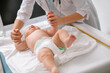 Experienced pediatrician checking the newborn grasp reflex