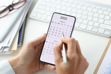 Smartphone On Screen With Calendar For 2022 Pen In Female Hands