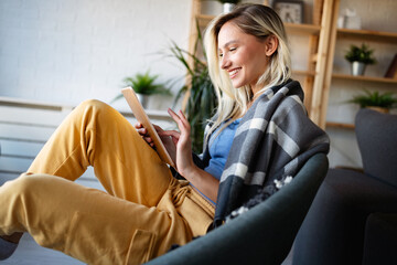 Happy young woman using tablet pc in loft apartment