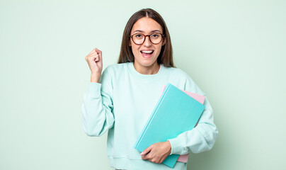 Poster - young pretty woman feeling shocked,laughing and celebrating success. universitary student