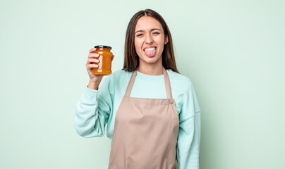 Poster - young pretty woman with cheerful and rebellious attitude, joking and sticking tongue out. peach jelly concept