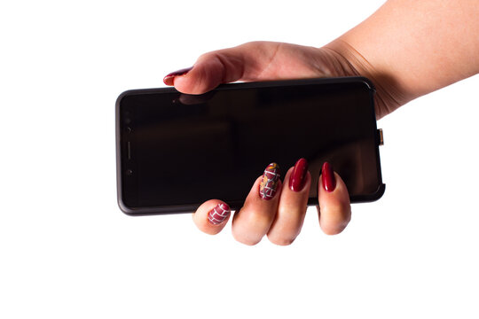 Female hand with manicure. Girl hand holding phone.