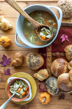 Top Down View Of Turkey Soup With A Variety Of Buns Scattered All Around.