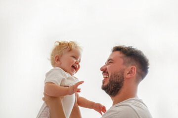 Wall Mural - Father and daughter spending quality time together. Bearded man with his adorable blonde toddler. Close up, copy space for text, background.