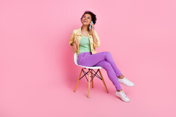 Poster - Full length photo of funny young brunette lady talk telephone wear shirt trousers shoes isolated on pink background