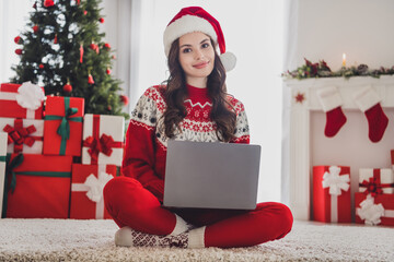 Canvas Print - Photo of freelancer lovely lady sit carpet typing netbook wear santa hat sweater pants socks in decorated home indoors