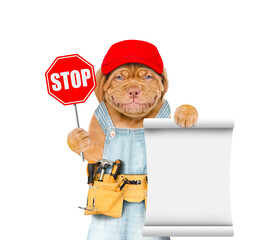 Poster - Smiling puppy wearing overalls with tool belt and blue cap shows stop sign and empty list. Isolated on white background