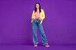 © deagreez - Full size photo of young cheerful lady arms in pocket cool standing isolated over violet color background